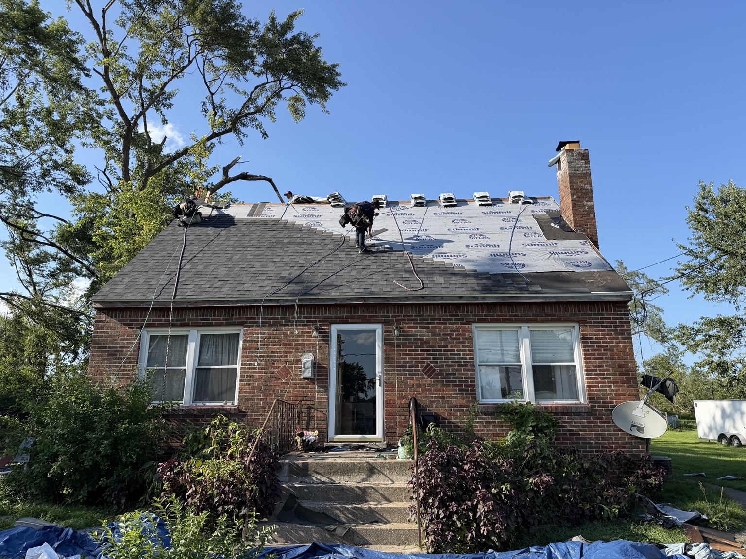 Crew installing the new roofing system